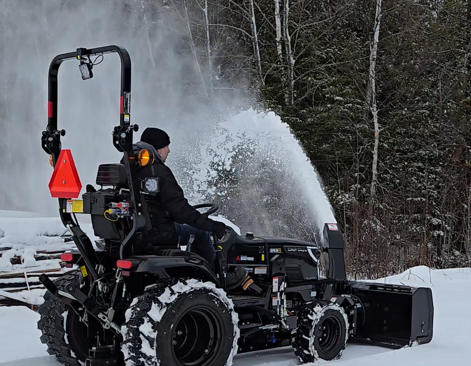 Captain 2532 tractor clearing snow with a snowblower attachment